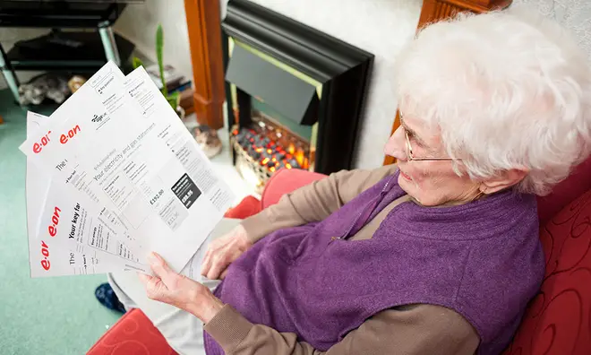Pensioner examining her energy bills