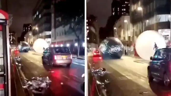 The giant baubles can be seen careering down through central London