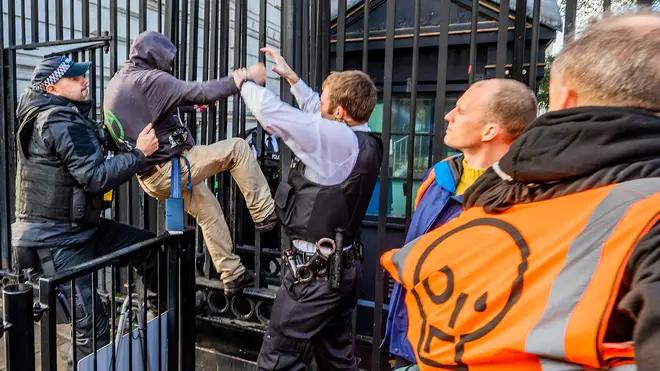 Police grabbed protesters off the Downing Street fencing