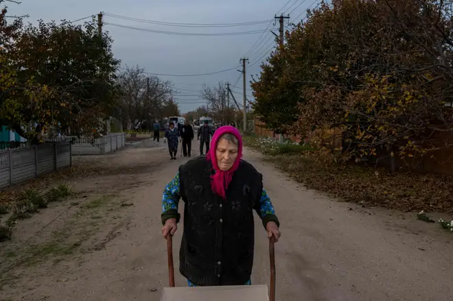 A Ukrainian woman with a box of humanitarian aid near Mykolaiv on Wednesday