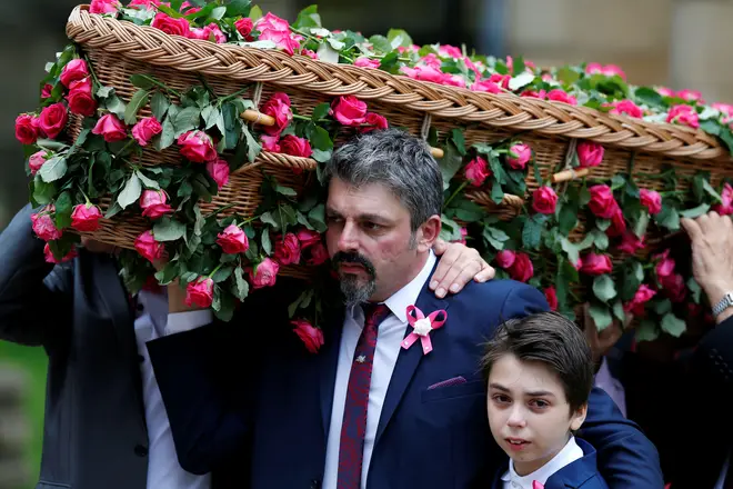 Andrew Roussos carries his daughter's coffin in July 2017