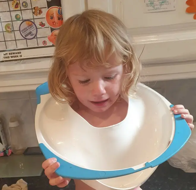 Harper with the toilet seat around her head