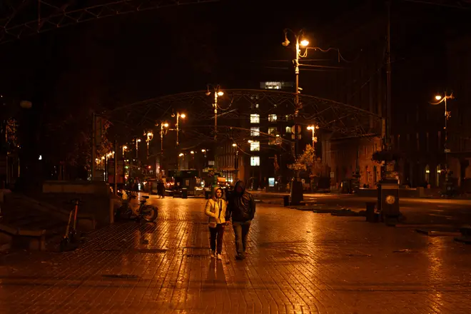 A couple walk down the street during a blackout in Kyiv