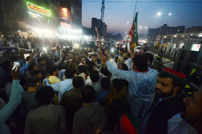 Supporters of Mr Khan protesting against the assassination attempt