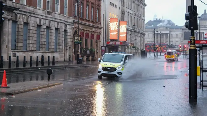 A sudden heavy shower has left Whitehall running like a river rather than a road.
