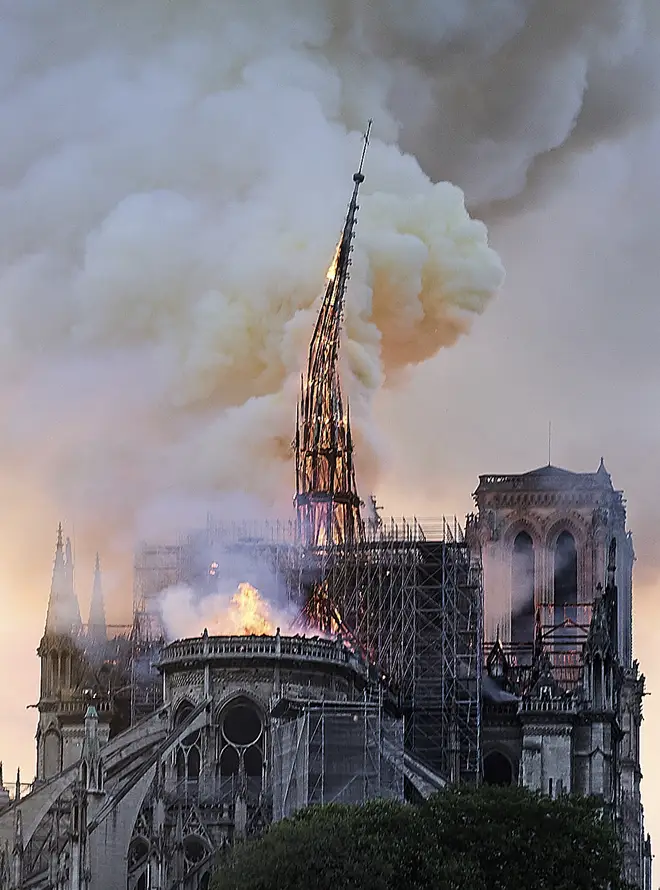 Flames and smoke rise as the spire on Notre Dame cathedral collapses in Paris