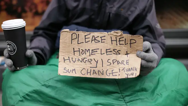 A homeless man asks for spare change