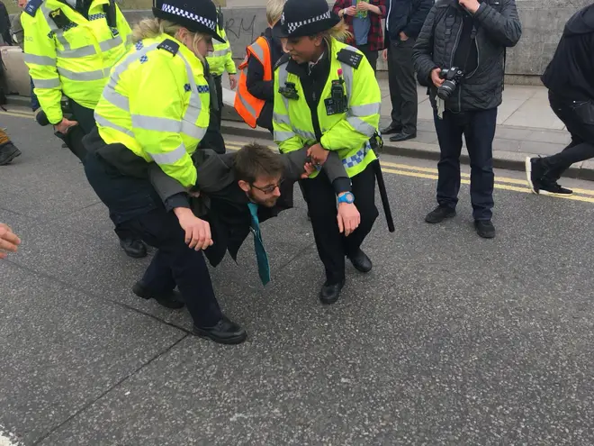 Police carried some protesters off Waterloo Bridge