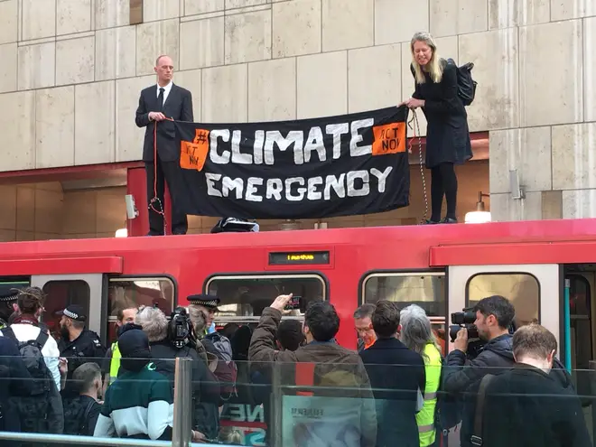 Protesters on top of a DLR train at Canary Wharf