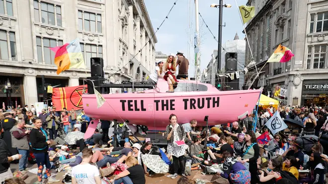 Climate change activists sat around a pink bus at Oxford Circus