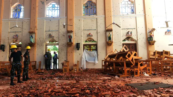 Investigators amongst the debris after an explosion at St Sebastian's Church in Negombo, Sri Lanka