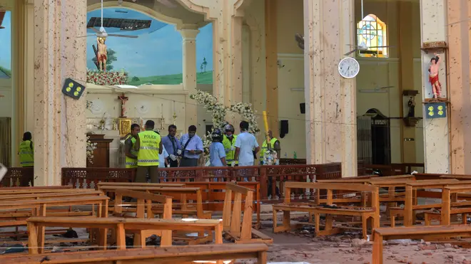 Investigators among the debris in St Sebastian's Church in Negombo