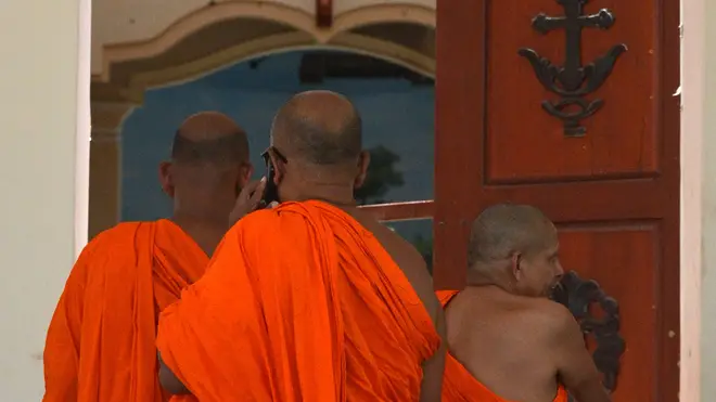 Sri Lankan Buddhist monks visit the site of a bomb attack at St. Sebastian's Church in Negombo