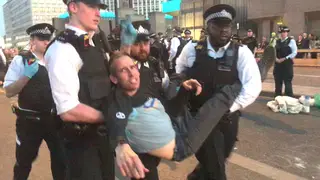 Olympic gold medallist Etienne Stott being arrested by police at the Extinction Rebellion demonstration on Waterloo Bridge in London.