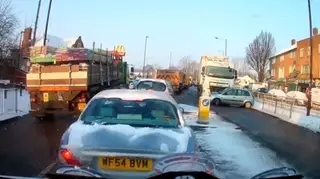 Lorry driver unknowingly pushes car 250ft down snowy road