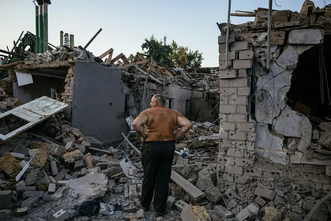 A man looks at his destroyed house in Mykolaiv, near Kherson