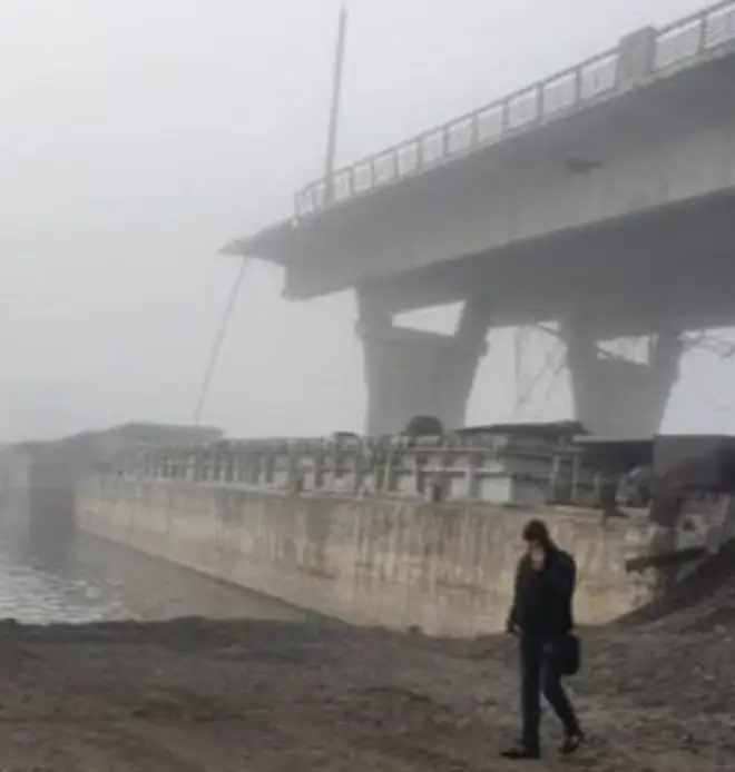 The destroyed bridge that the Russians used to flee across the Dnipro river