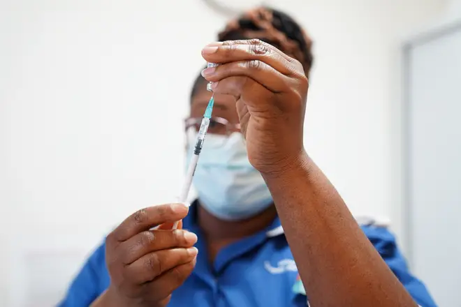 A nurse prepares a dose of a Covid-19 booster vaccine this year