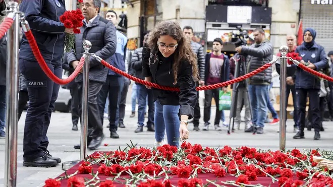 Citizens leave 'carnations to condemn' a day after the deadly blast