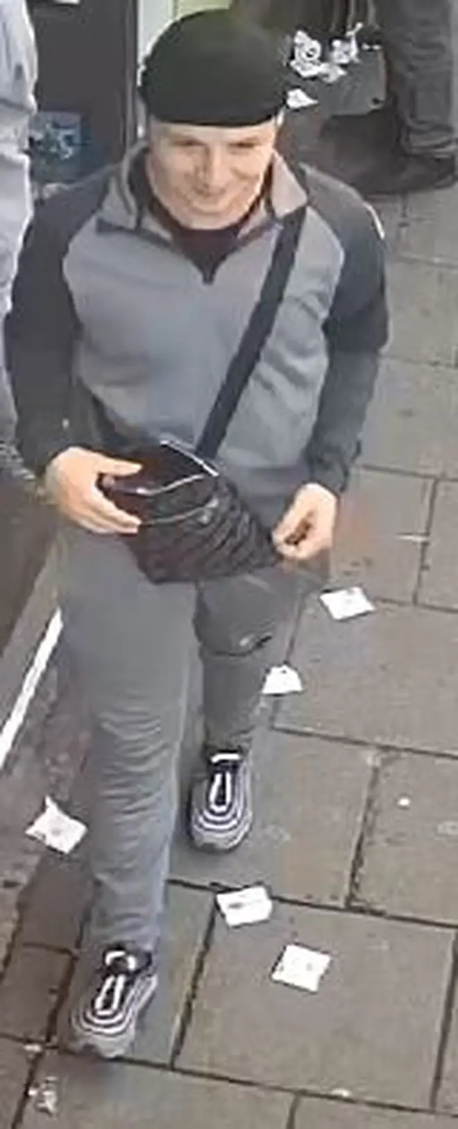 The second suspect leaving the shop