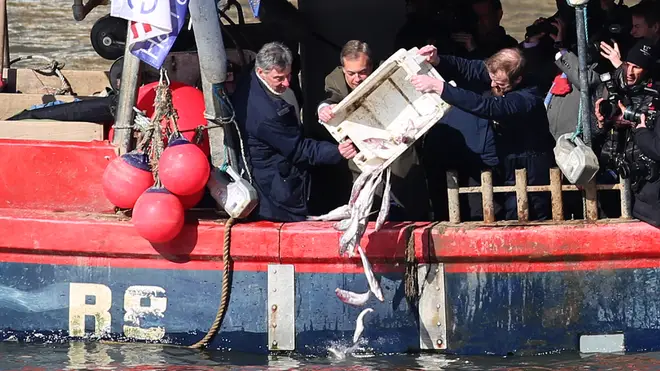 Nigel Farage tips fish into the River Thames
