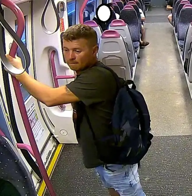 CCTV images of a man who exposed himself to victim on a London train - wearing black T-shit and blue shorts.