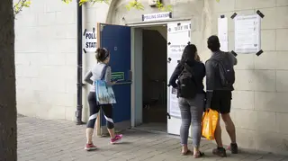 Voters read the instructions outside a polling station in Greenwich