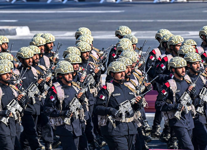 Members of the Qatari armed forces take part in a military parade.