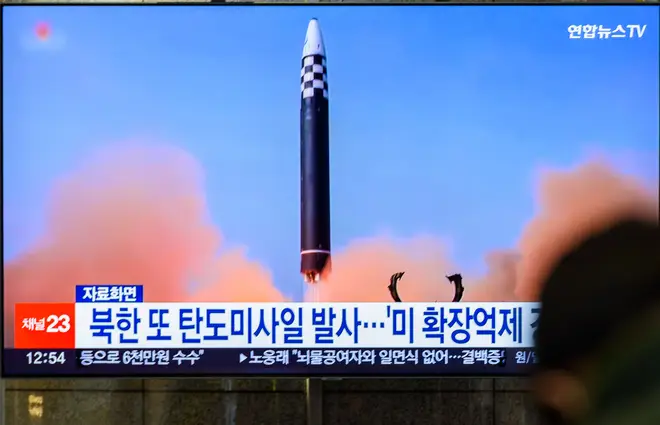A TV screen shows a file image of North Korea's missile...