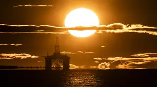 Sun rise behind a redundant oil platform