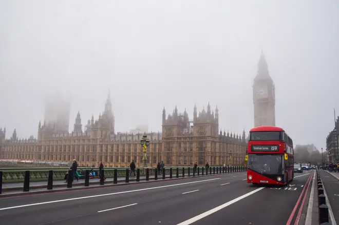 A bus passes by the Houses of Parliament and Big Ben on...