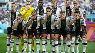 The Germany team cover their mouths in their team photo in protest