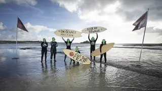 Representatives from Surfers against Sewage protest against sewage discharges at an overflow pipe on Long Rock Beach in Penzance, Cornwall