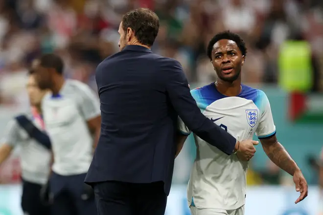 Gareth Southgate, Head Coach of England, and Raheem Sterling of England interact as he is substituted