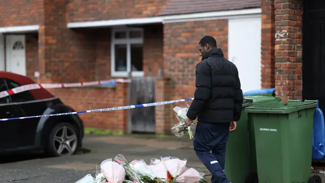A member of the public lays flowers at the scene of one stabbing