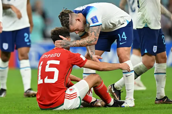 Kalvin Phillips of England consoles Ethan Ampadu of Wales