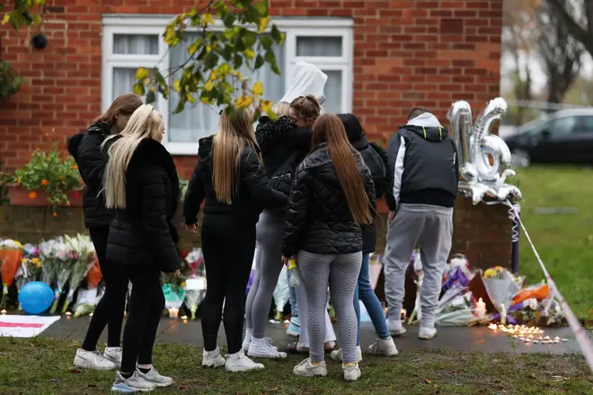 People pay tribute at the scene of a stabbing on Sewell Road in Abbey Wood