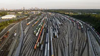 Freight train cars sit in a Norfolk Southern rail yard