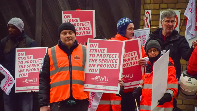 Royal Mail workers stand at the picket line outside the Islington Delivery Office