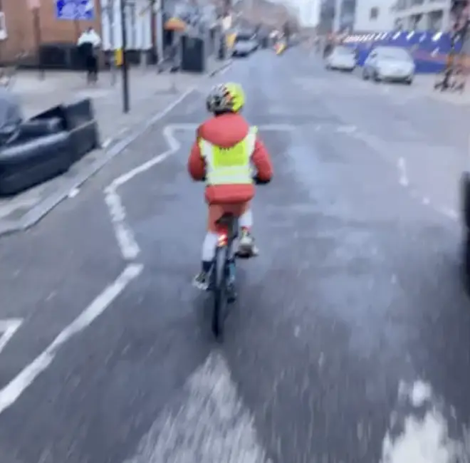 The child cycling as the van approaches