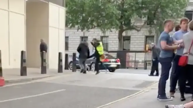 The shocking moment a homeless man is kicked in the back by a security guard in Westminster