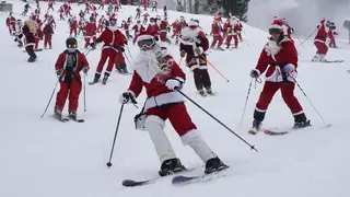 Skiers dressed in Santa Claus outfits hit the slopes for charity at the Sunday River Ski Resort in Newry, Maine