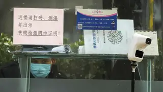 A security guard outside an office building in Beijing