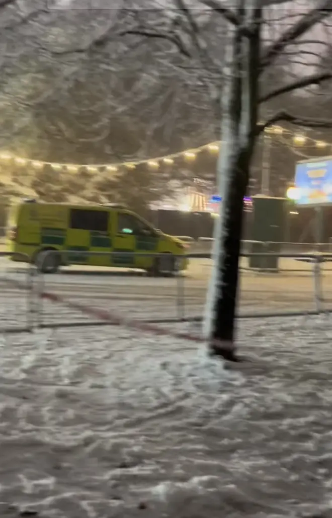 An ambulance leaving the scene