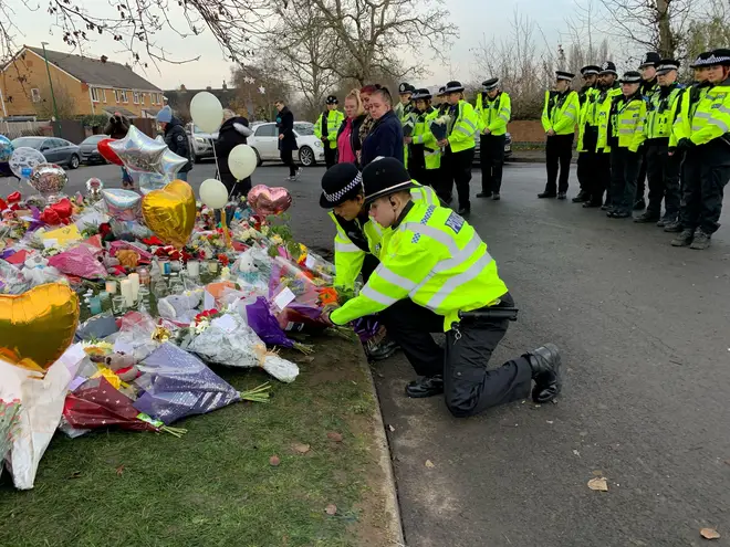 Police officers leave their tributes to the boys.