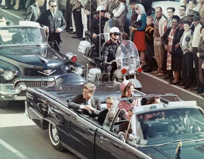 US President John F Kennedy, First Lady Jacqueline Kennedy, Texas Governor John Connally, and others smile at the crowds lining their motorcade route in Dallas, Texas, on November 22, 1963. Minutes later the President was assassinated.