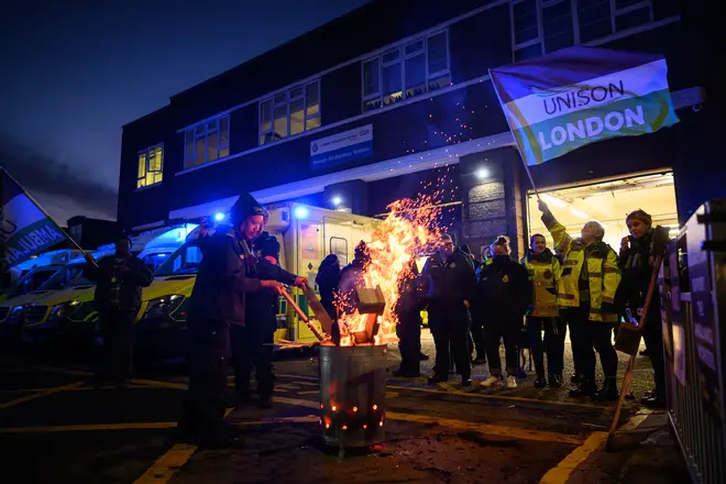 Ambulance workers and supporters gather outside Kenton Ambulance Station during the strike