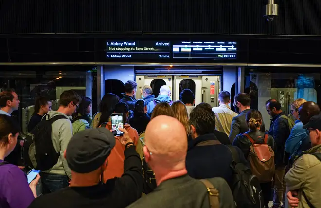 Passengers boarding an Elizabeth Line train in London, May 24, 2022, on the new line's first-day of service.