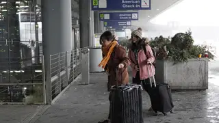 Travelers arrive at Terminal 3 at O’Hare International Airport