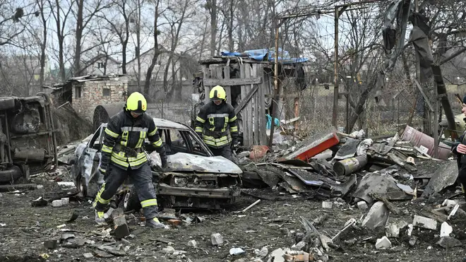 Rescuers clear debris of homes destroyed by a missile attack in the outskirts of Kyiv